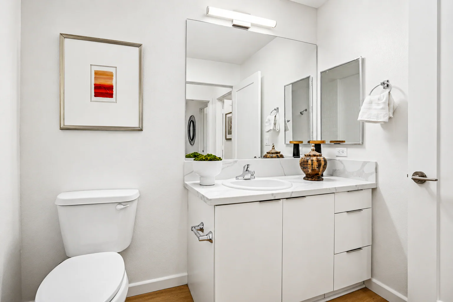Bathroom vanity with marble countertop and chrome fixtures