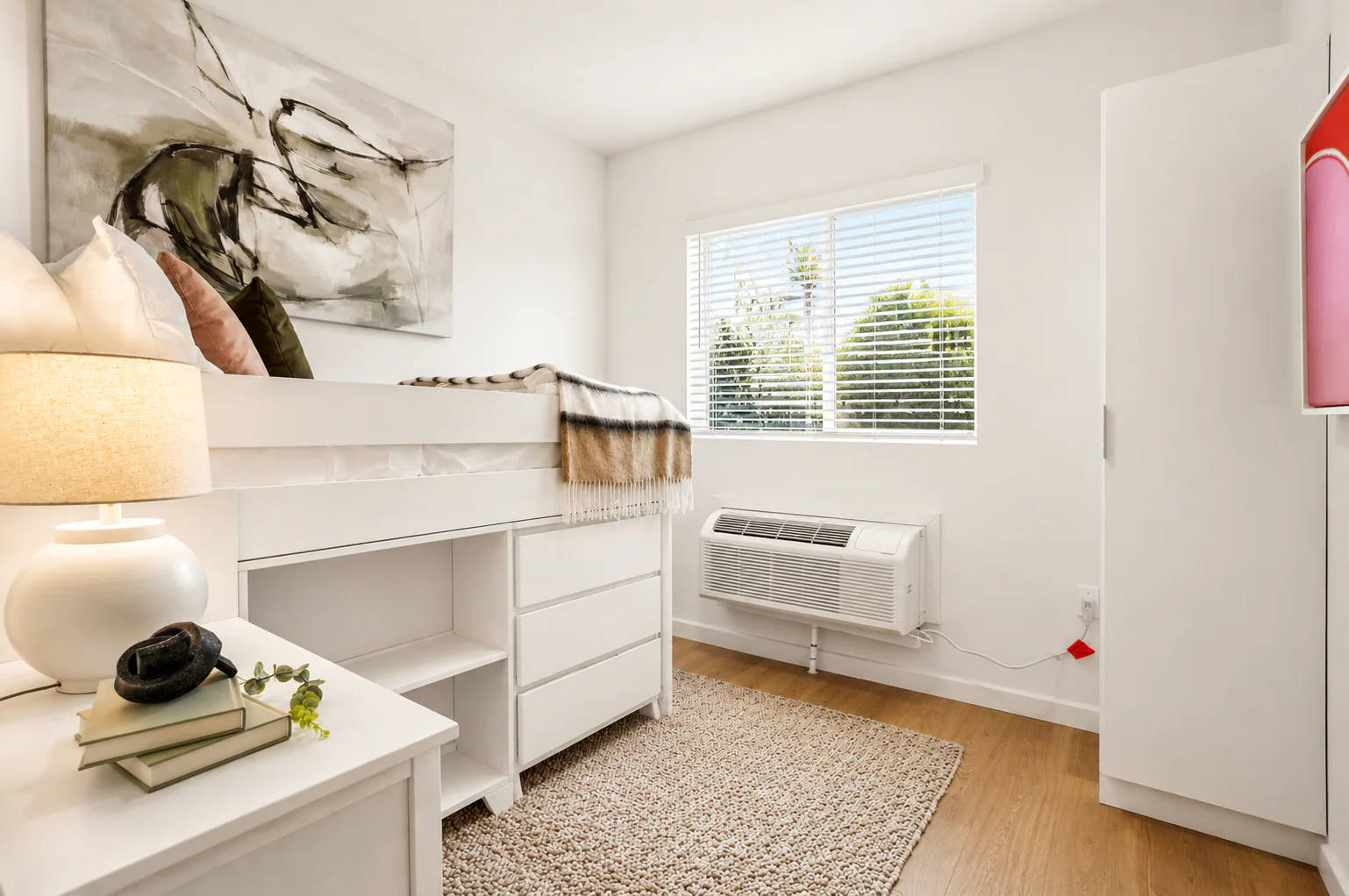 Bedroom with loft-style bed, under-bed storage, and wardrobe