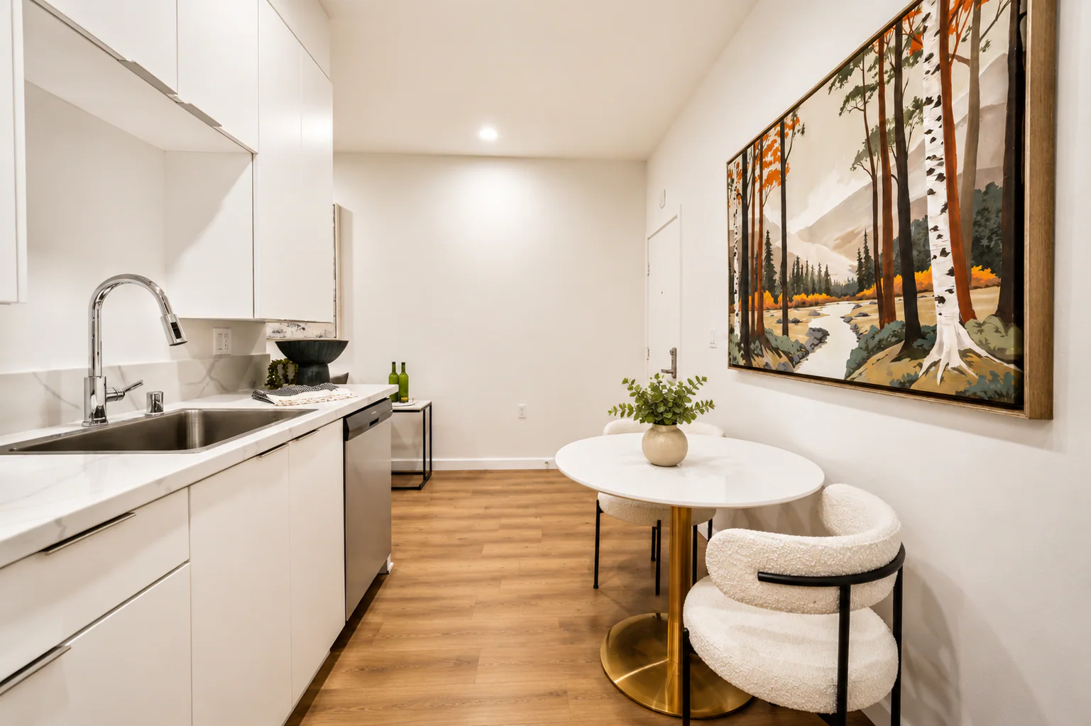 Kitchen sink and dining nook with round table at Haven on Orange