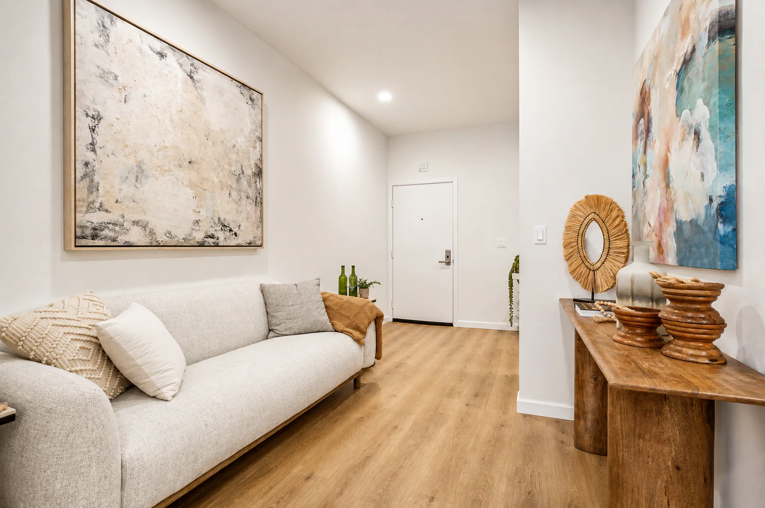 Entry hallway with sofa, console table, and front door